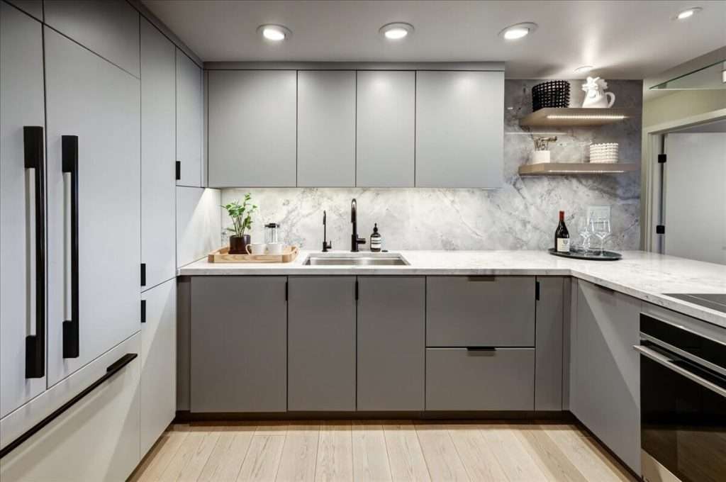 Image of modern kitchen featuring freshly painted slab door cabinets.