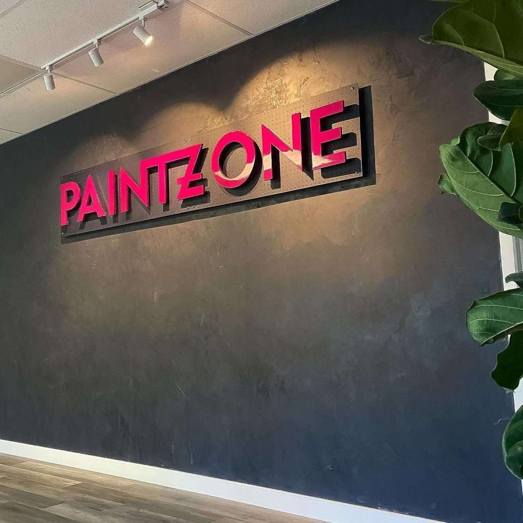 Gray accent wall in an office, featuring painted high-gloss accents, walls plastered in Roman Clay.